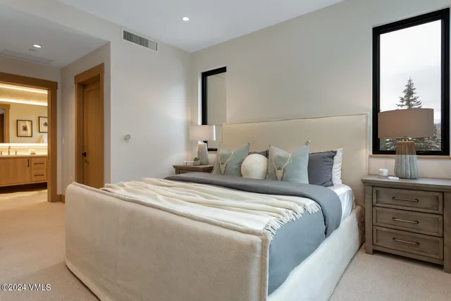 a bedroom with a bed and a night stand