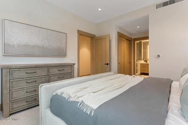 a bedroom with a bed and a dresser