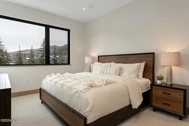 a bed room with a bed and a large window