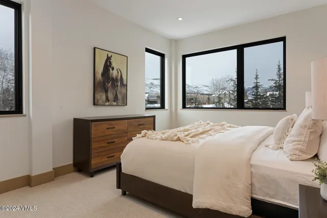 a bedroom with a bed and a large window