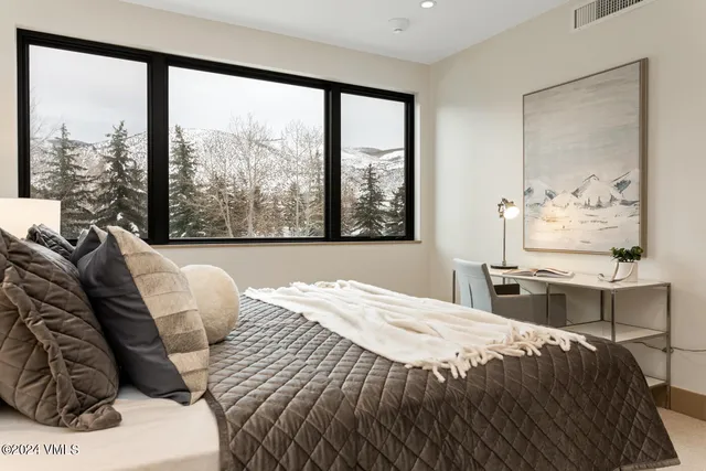 a bedroom with a bed and glass window