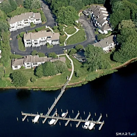 an aerial view of a residential houses with yard