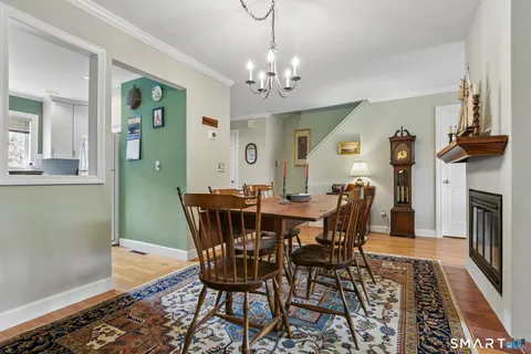a view of a dining room with furniture and a chandelier