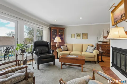a living room with furniture a large window and a fireplace
