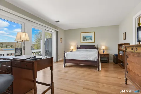 a bedroom with a bed and a table