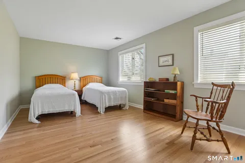 a bedroom with furniture and a window