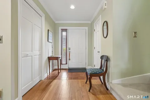 a view of a room with furniture and wooden floor