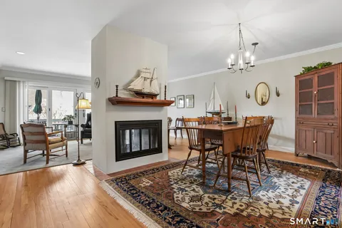 a view of a a dining room with furniture window and wooden floor