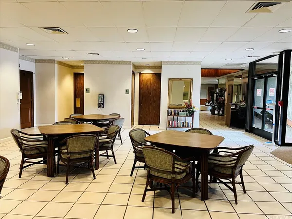 a dining room with a wooden table and chairs