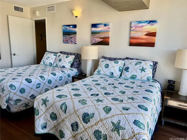 a bedroom with a bed and a painting on the wall
