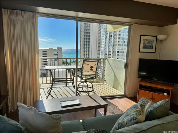 a view of a livingroom with furniture and a flat screen tv