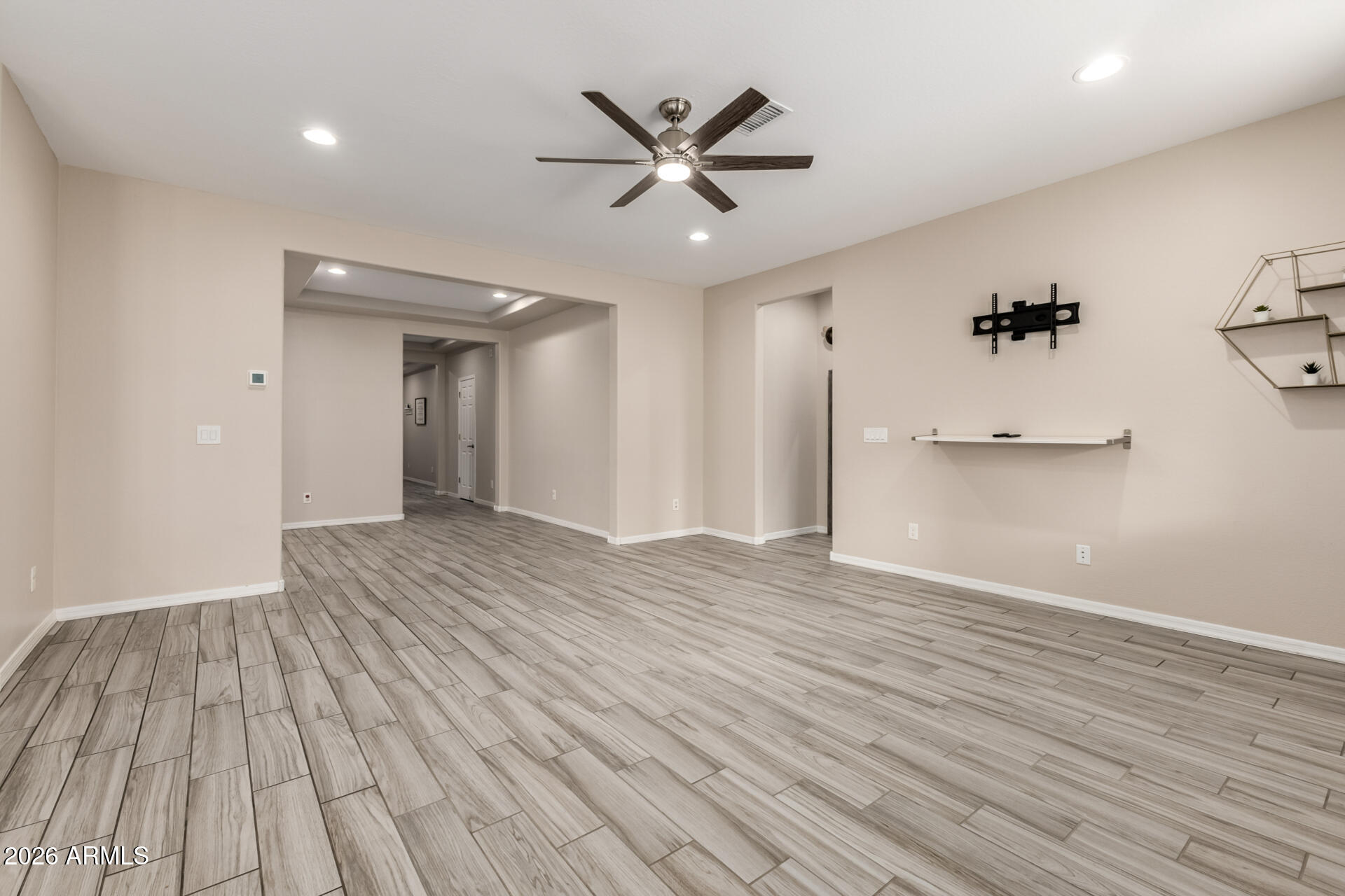 5347 West Lydia Lane Laveen, AZ 85339 - Photo 10 of 48 a view of empty room with wooden floor and ceiling fan