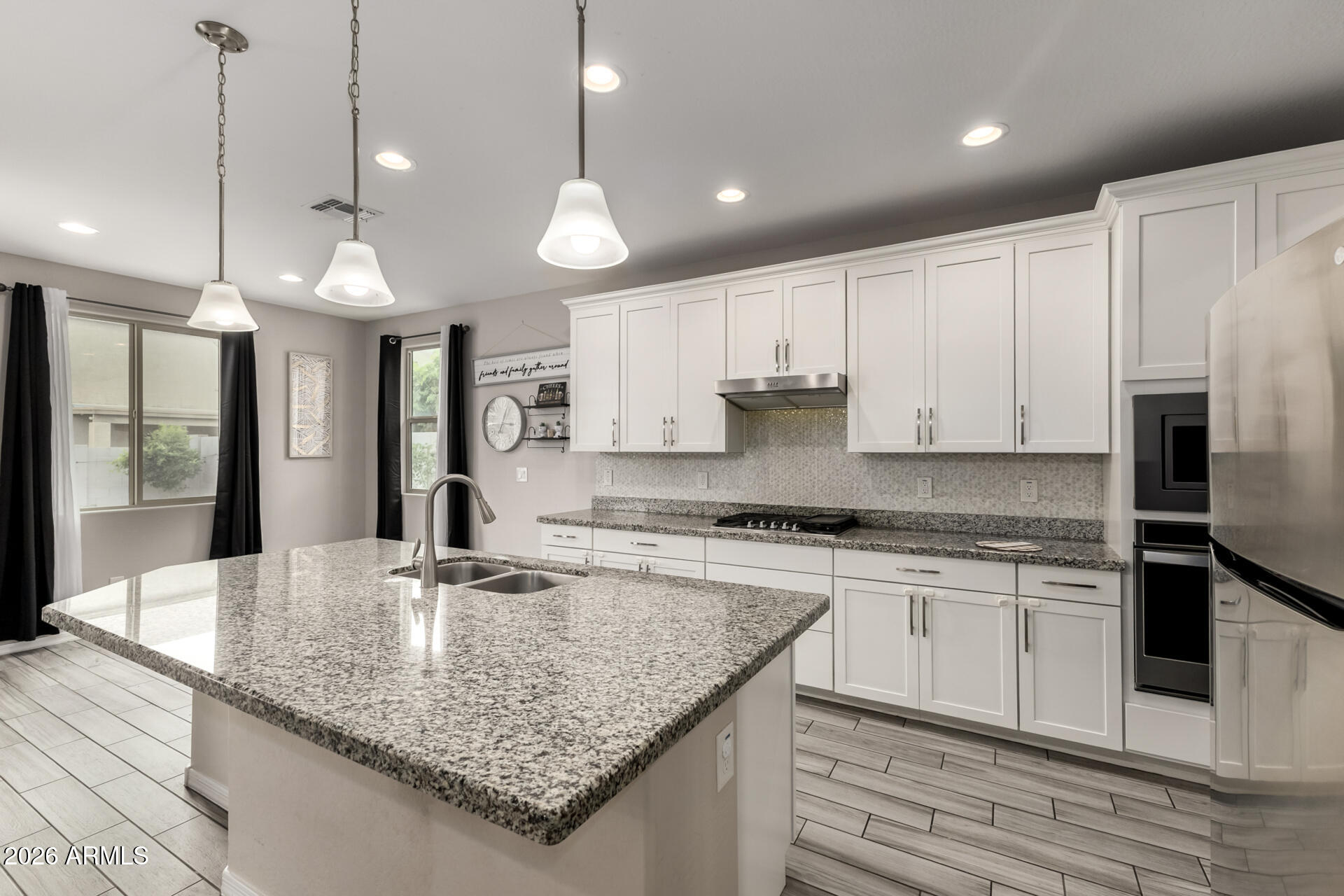 5347 West Lydia Lane Laveen, AZ 85339 - Photo 19 of 48 a kitchen with stainless steel appliances granite countertop a sink refrigerator and cabinets
