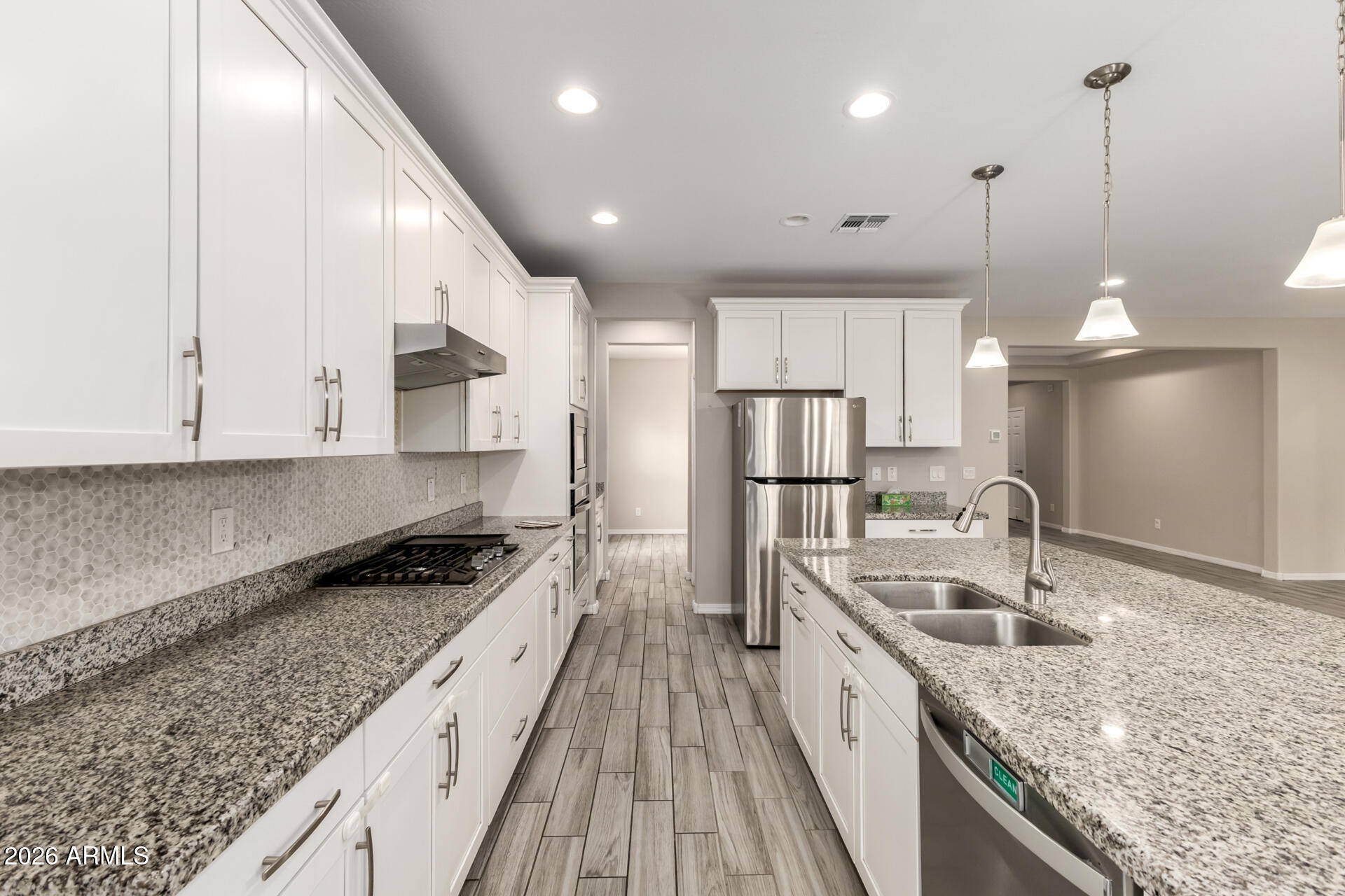 5347 West Lydia Lane Laveen, AZ 85339 - Photo 20 of 48 a kitchen with stainless steel appliances granite countertop a sink a stove and a refrigerator