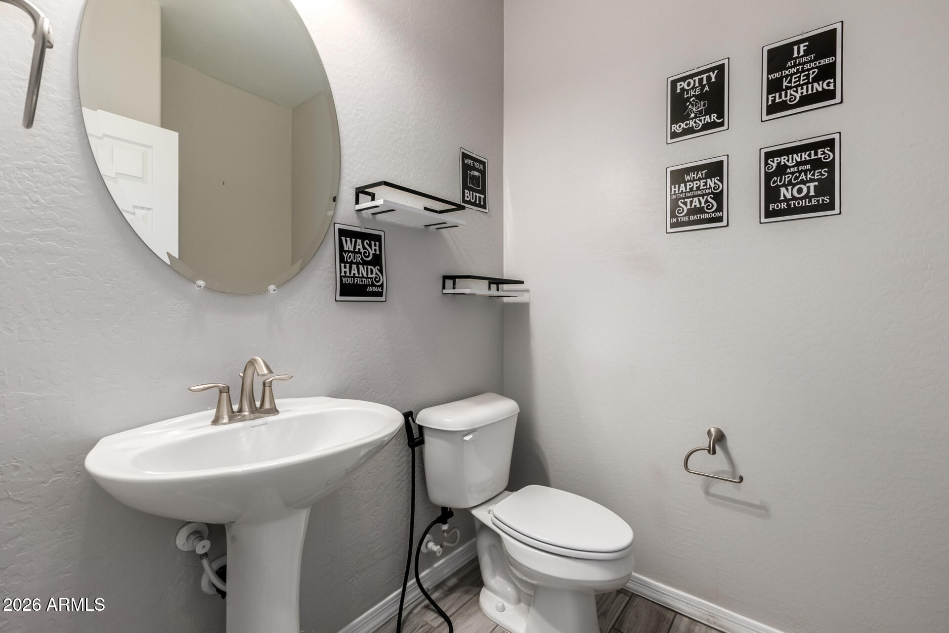 5347 West Lydia Lane Laveen, AZ 85339 - Photo 22 of 48 a bathroom with a toilet sink and mirror