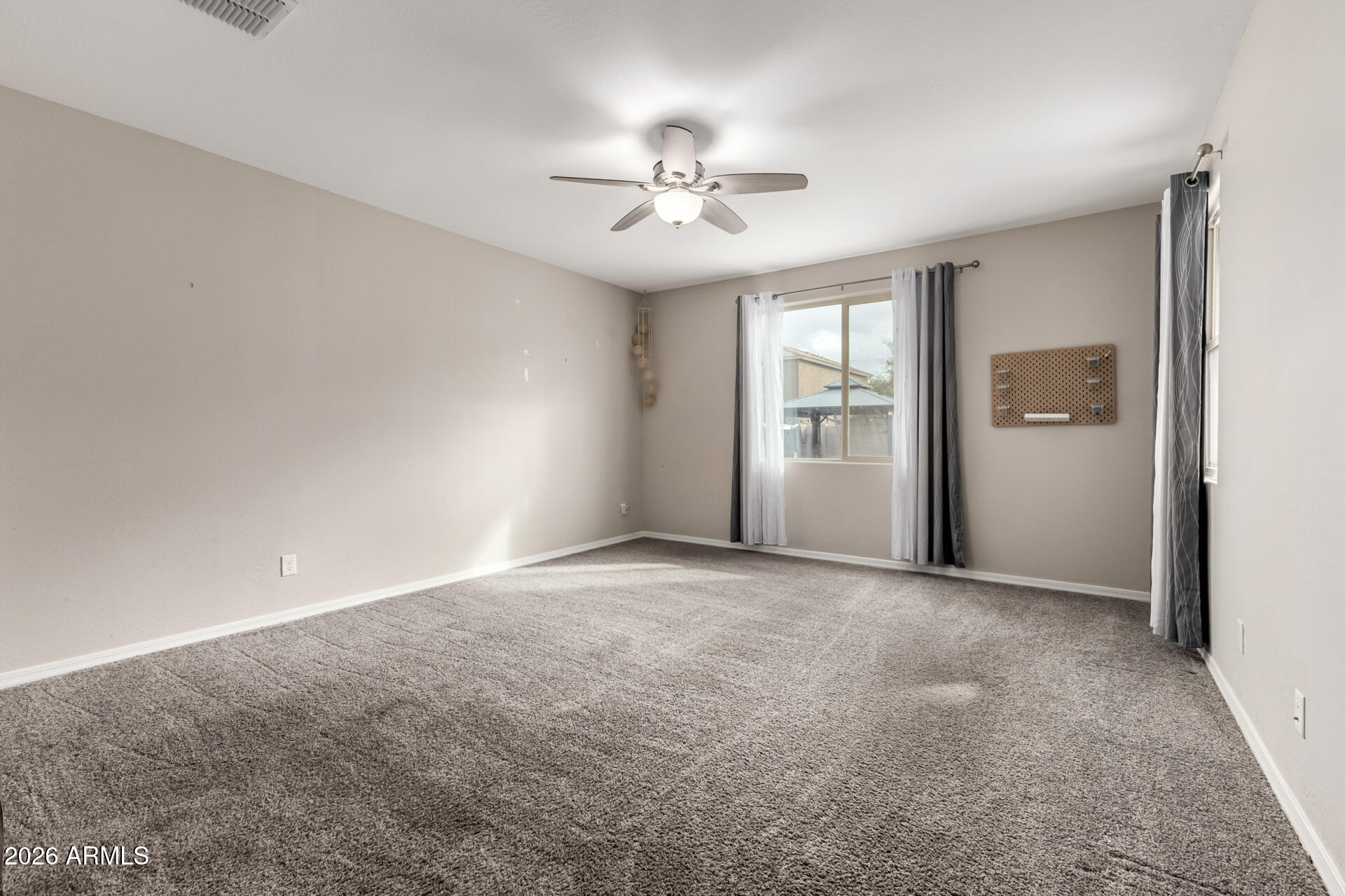 5347 West Lydia Lane Laveen, AZ 85339 - Photo 23 of 48 a view of a livingroom with a ceiling fan and window