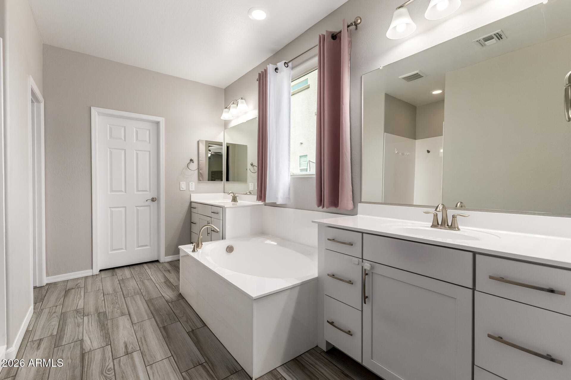 5347 West Lydia Lane Laveen, AZ 85339 - Photo 27 of 48 a bathroom with a sink a mirror and a bathtub