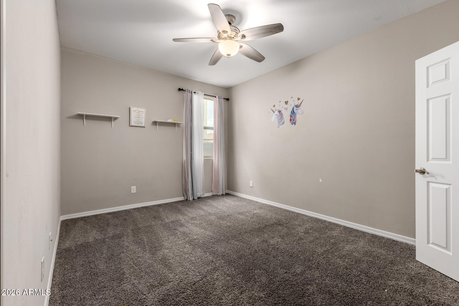 5347 West Lydia Lane Laveen, AZ 85339 - Photo 35 of 48 an empty room with a ceiling fan and a window