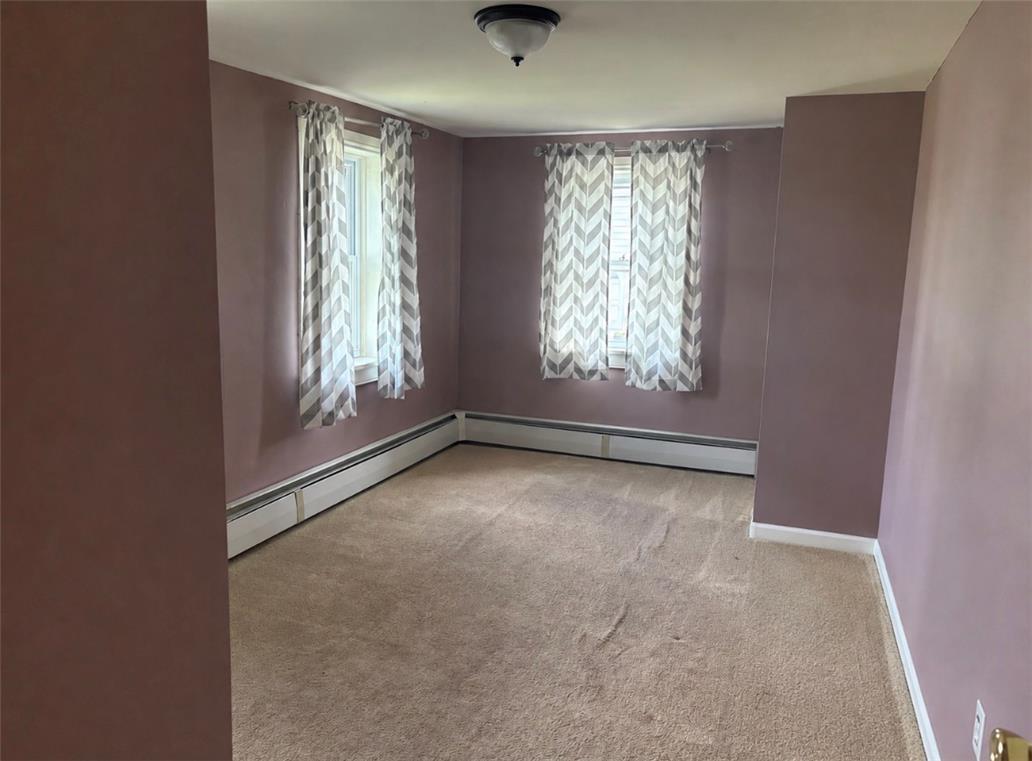 7281 Decatur Street New Tripoli, PA 18066 - Photo 17 of 27 Natural light filters through two windows, illuminating the plush, neutral-toned carpeting.