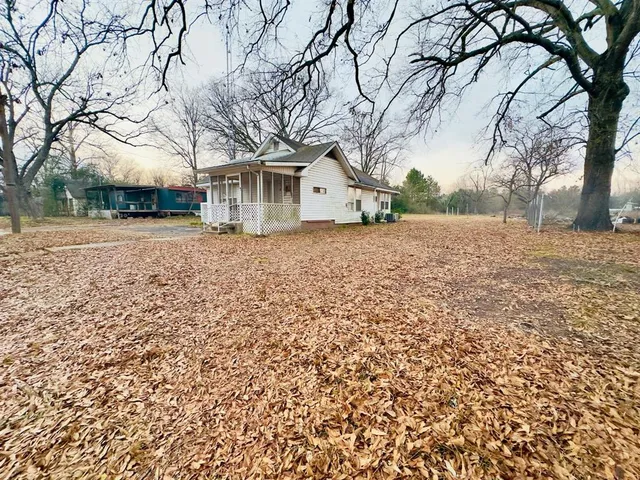 a front view of house with yard and trees