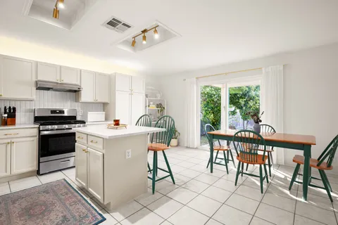 a bathroom with a sink a toilet and shower curtain
