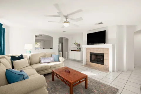 a view of a livingroom with workspace and a window