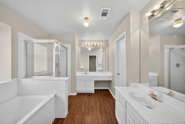 a bathroom with a bathtub sink and mirror