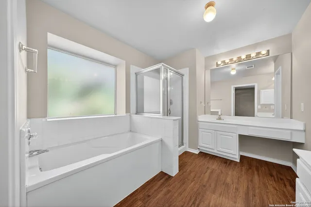 a bathroom with a bathtub and a sink