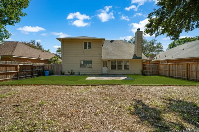 a view of a house with backyard and sitting area