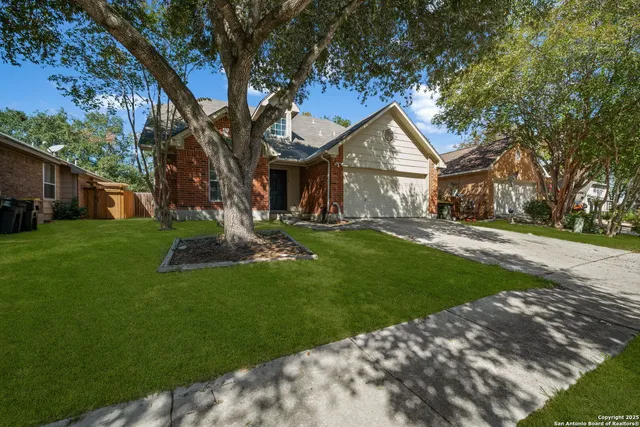 a house with green field in front of it