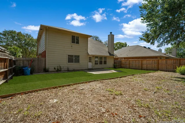 a front view of house with a garden