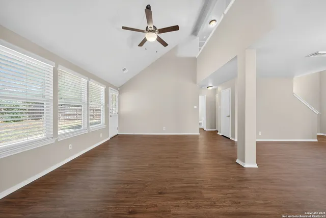 a view of a livingroom with a ceiling fan and window