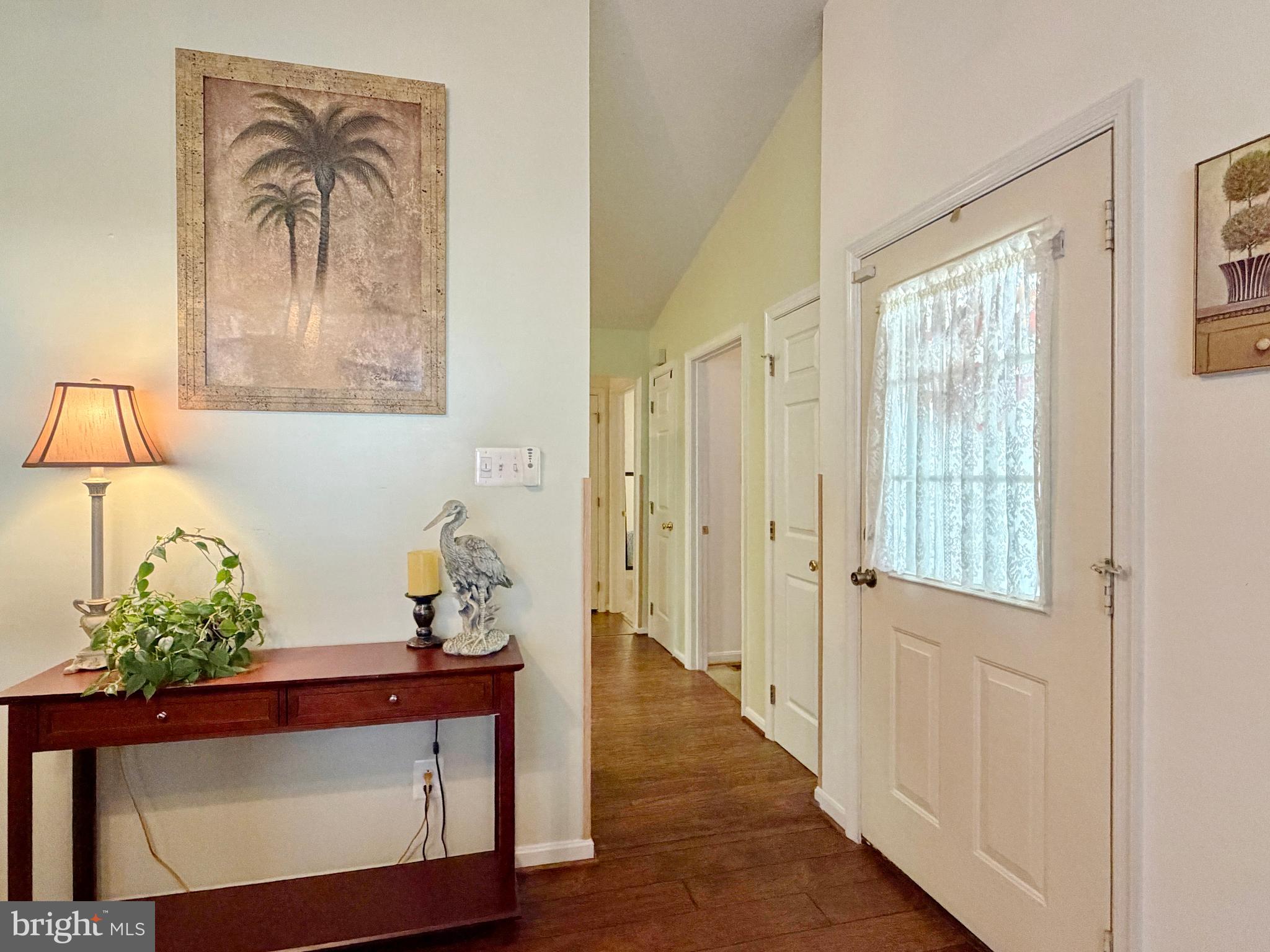 17466 Audrey Road Cobb Island, MD 20625 - Photo 17 of 59 a view of a hallway with wooden floor and a potted plant