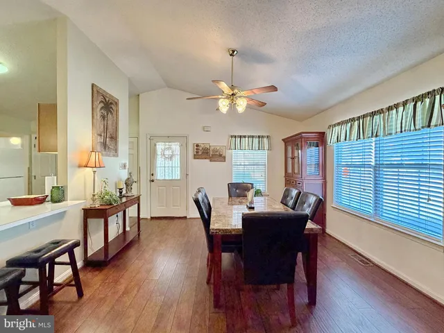 a kitchen with a sink cabinets and wooden floor