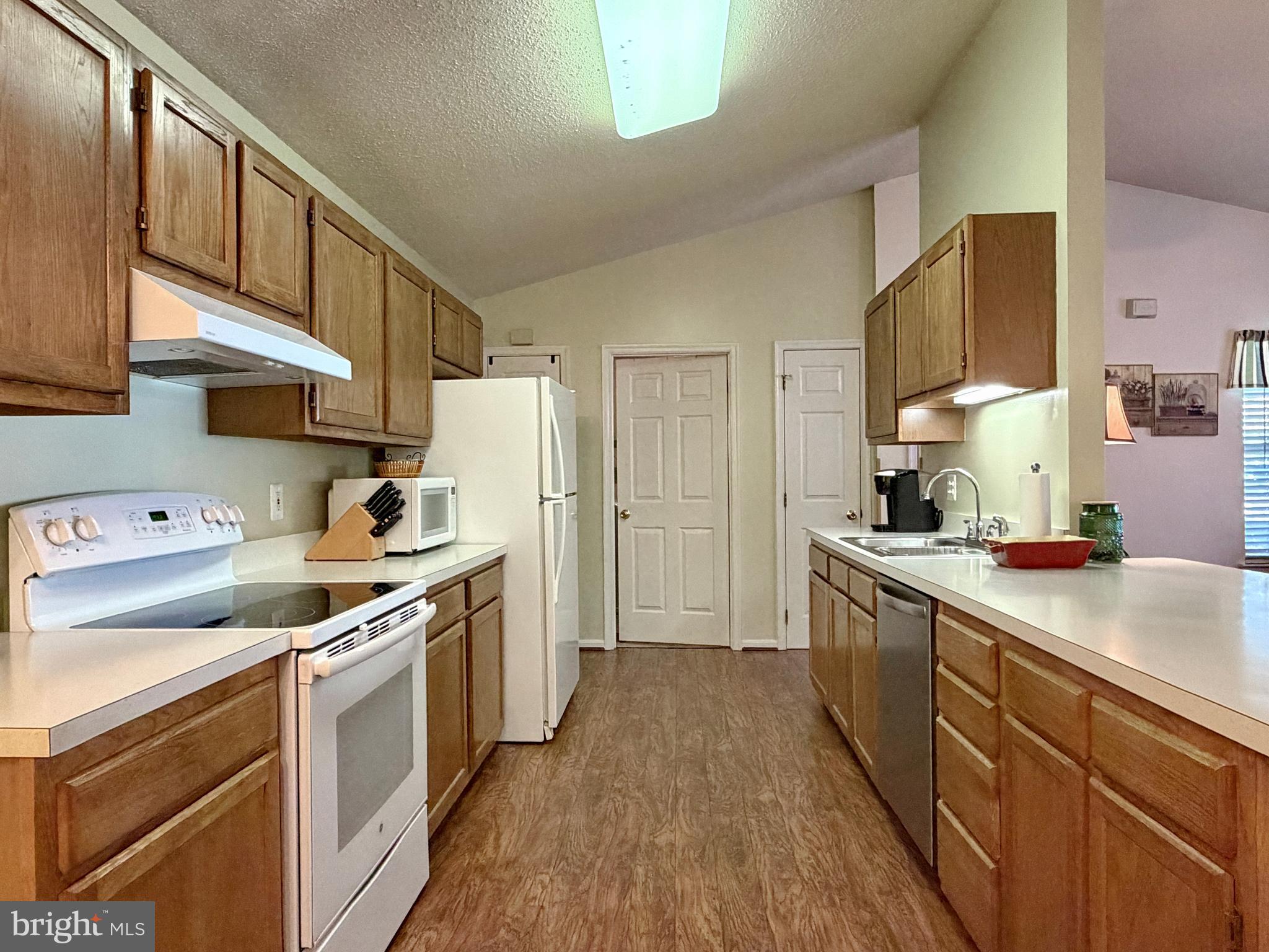 17466 Audrey Road Cobb Island, MD 20625 - Photo 25 of 59 a kitchen with a stove a sink and a refrigerator