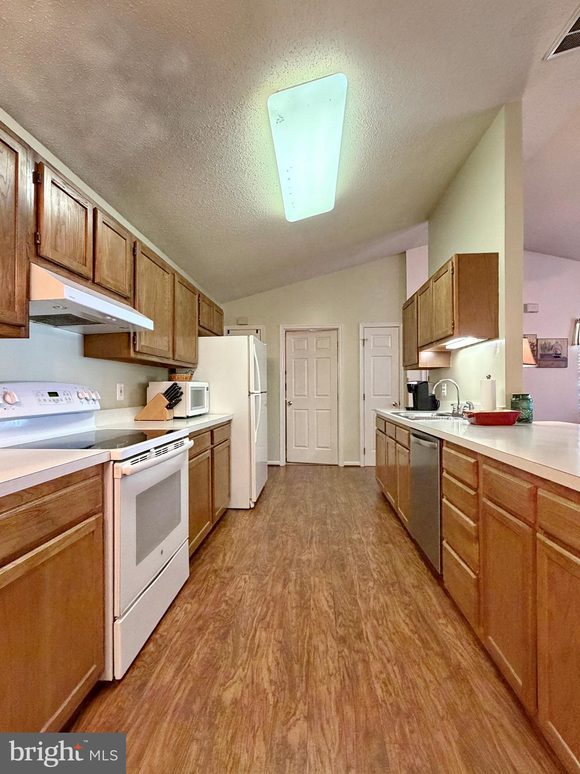 17466 Audrey Road Cobb Island, MD 20625 - Photo 26 of 59 a kitchen with granite countertop a sink cabinets stainless steel appliances and a counter top space
