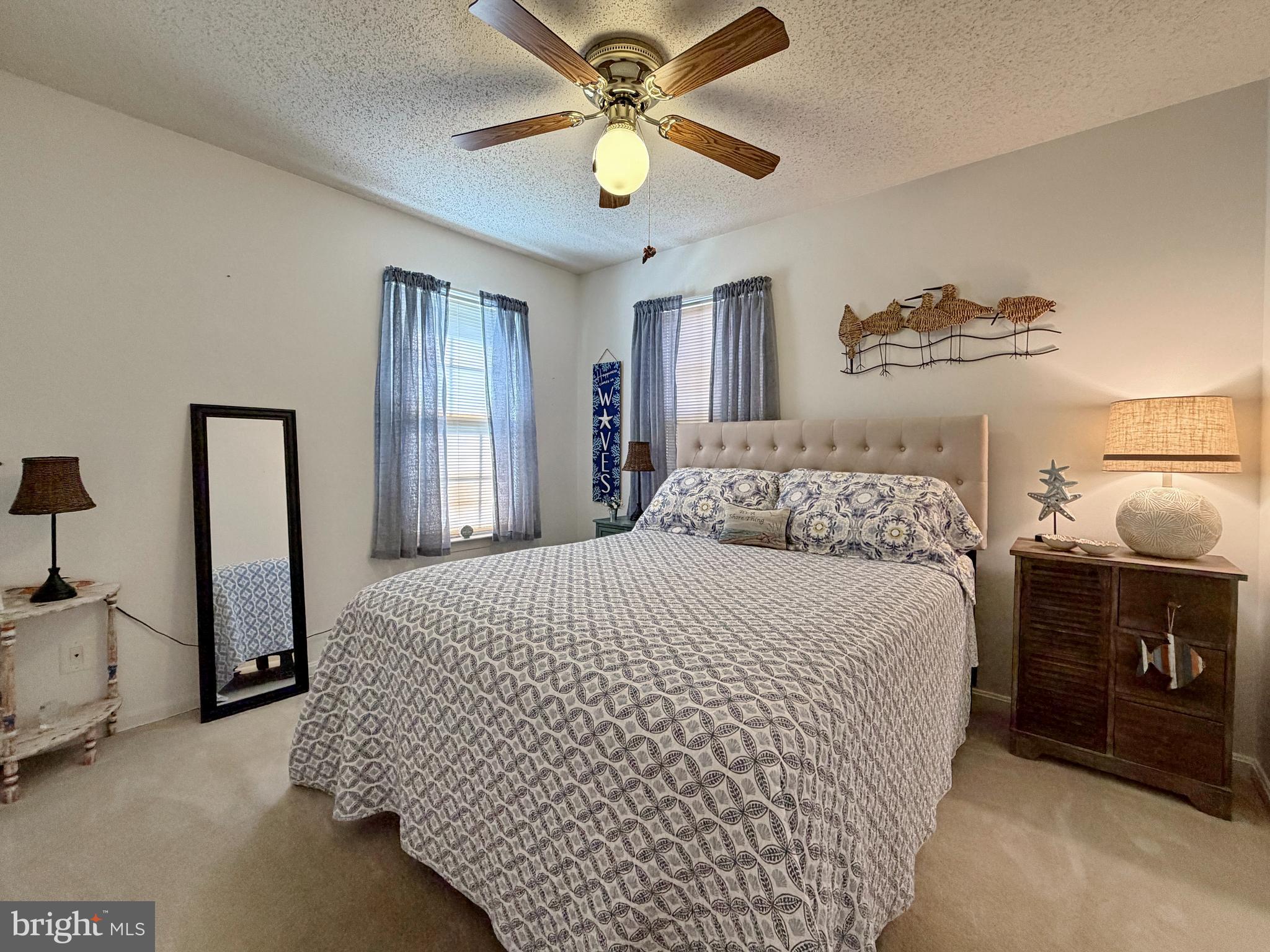 17466 Audrey Road Cobb Island, MD 20625 - Photo 42 of 59 a bedroom with a bed and a chandelier