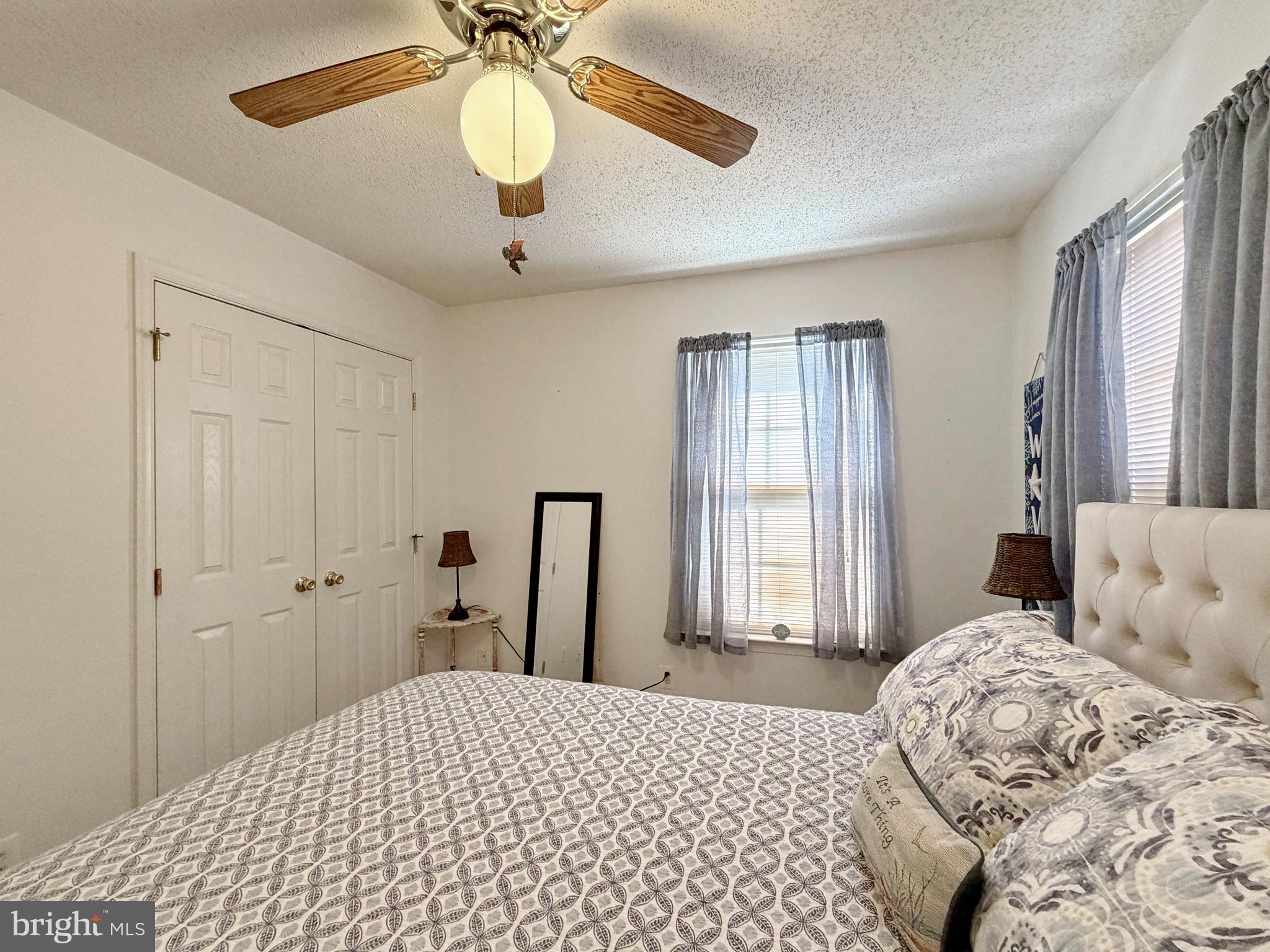 17466 Audrey Road Cobb Island, MD 20625 - Photo 43 of 59 a bedroom with a bed and a chandelier