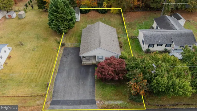 an aerial view of a house with a yard basket ball court and outdoor seating