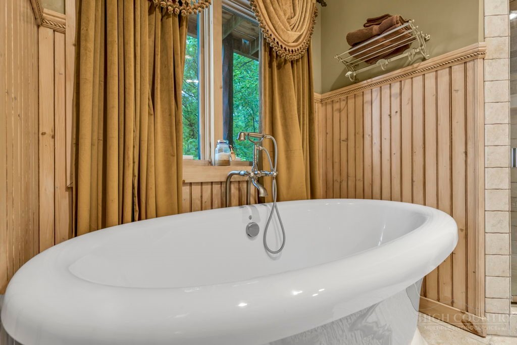 160 Outback Road Ferguson, NC 28624 - Photo 40 of 49 a bath tub sitting in a bathroom next to a window