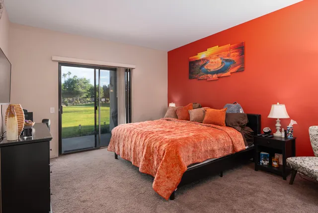 a spacious bedroom with a bed and a window