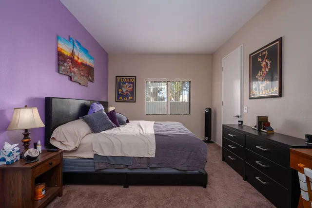 a bedroom with a bed and dresser