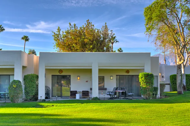 a view of a house with swimming pool and a yard