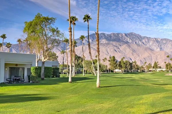 a front view of a building with a garden