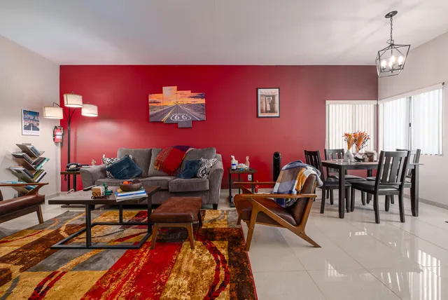a living room with furniture a rug and a chandelier