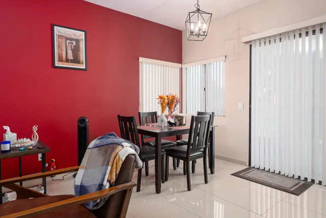 a dining room with furniture and window