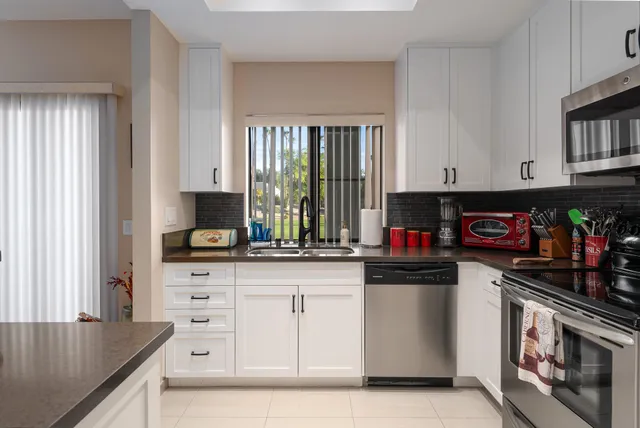 a kitchen with stainless steel appliances granite countertop a stove and a sink