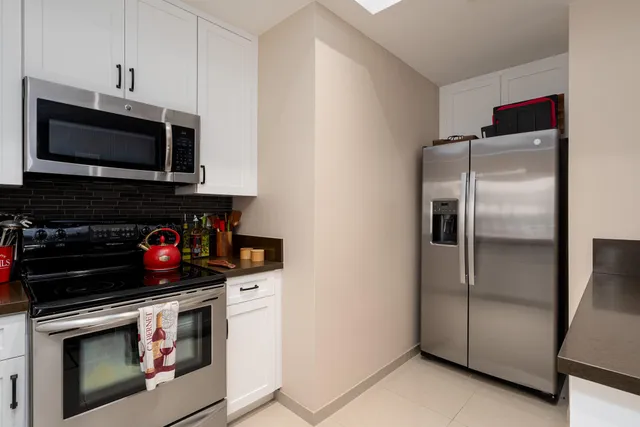 a kitchen with stainless steel appliances granite countertop a stove and a microwave