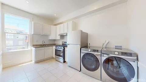 a utility room with sink dryer and washer
