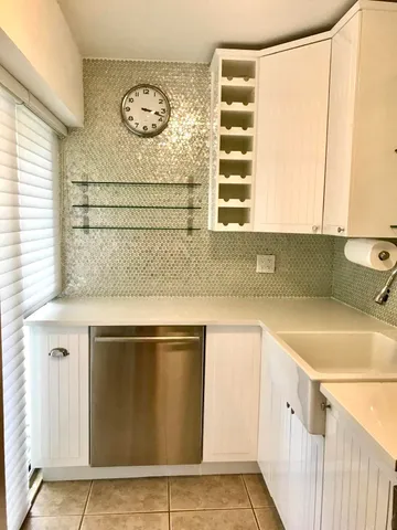 a kitchen with a sink cabinets and a window
